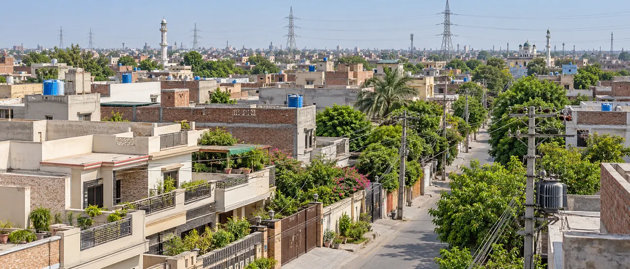 AI-generated illustrative residential scene inspired by Gujranwala, with rooftops and electricity infrastructure